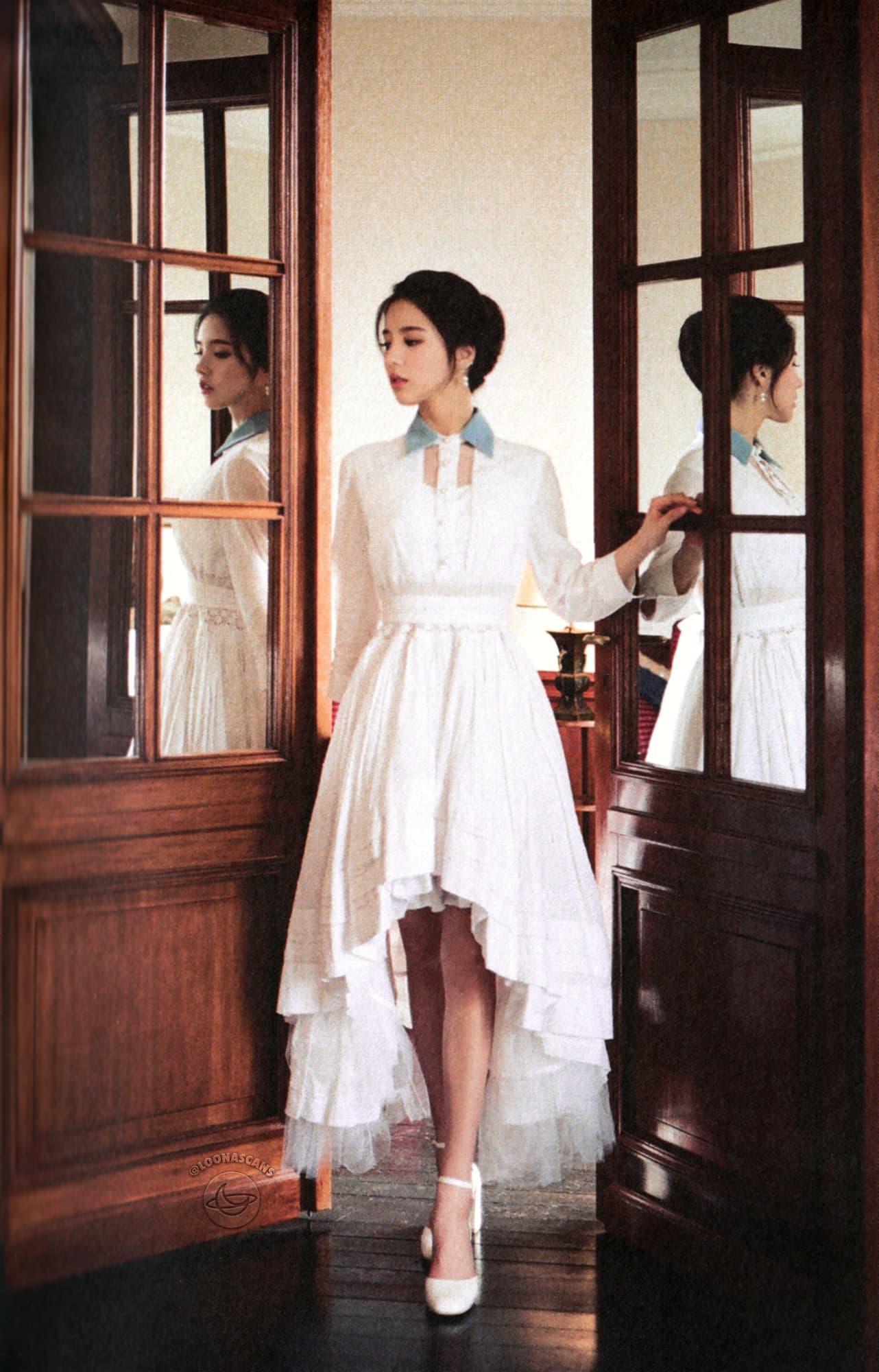Heejin wearing a white dress with a blue collar.